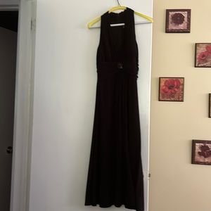 Black tea length cocktail dress. With waist embellishment. Sleeveless
